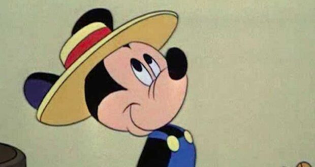 Mickey mouse with a blue shirt and a hat