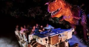 A group of people in a ride vehicle on DINOSAUR
