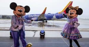 Mickey and Minnie standing in front of a Southwest Plane