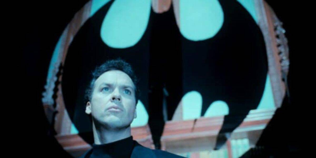 Michael Keaton as Bruce Wayne in front of the Bat signal