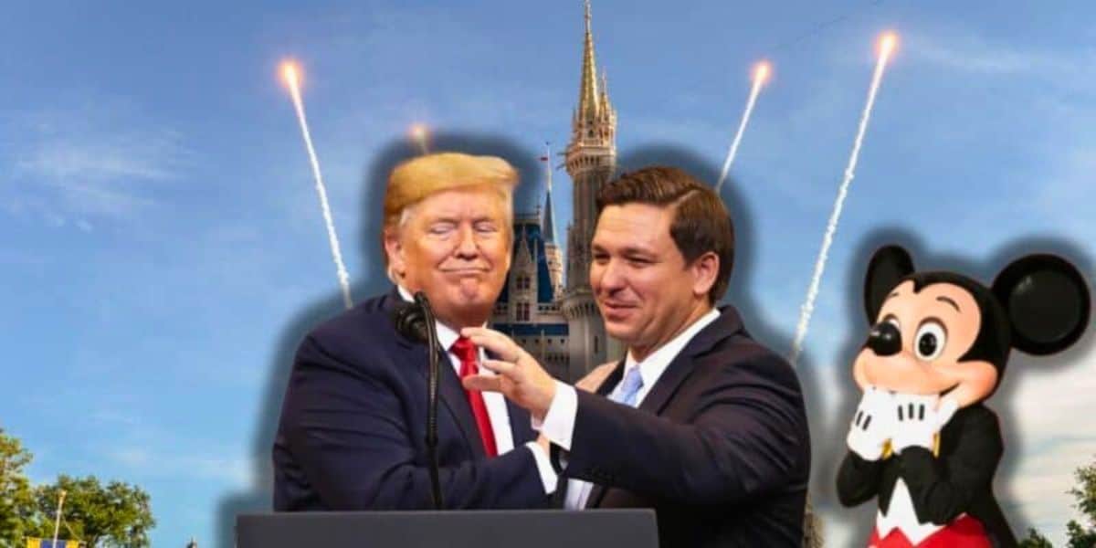 Donald Trump and Ron DeSantis in suits, one with a red tie and the other a blue tie, stand together smiling with fireworks and a castle in the background. On the right, Mickey Mouse from Disney poses with his hands on his cheeks.