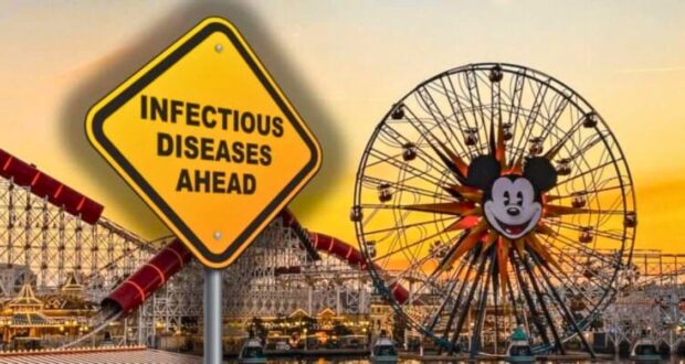 A large yellow caution sign reading "Infectious Diseases Ahead" is superimposed over an amusement park scene at sunset. The park, reminiscent of a Disney wonderland, features a Ferris wheel with a large Mickey Mouse face at its center and various roller coasters in the background.