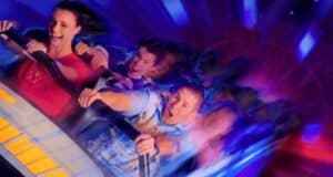 A man and a woman in a Disneyland ride vehicle - Space Mountain.