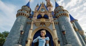 Cinderella standing in front of Cinderella Castle at Walt Disney World's Magic Kingdom