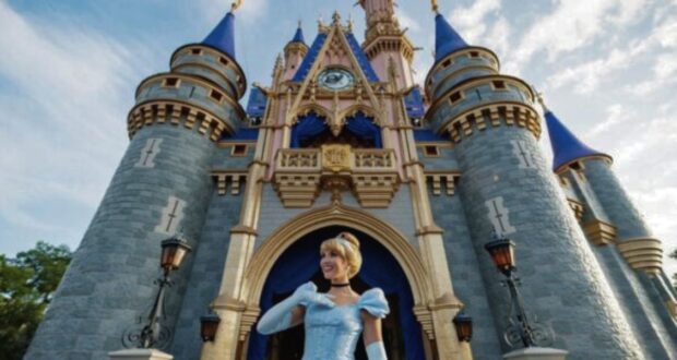 Cinderella standing in front of Cinderella Castle at Walt Disney World's Magic Kingdom