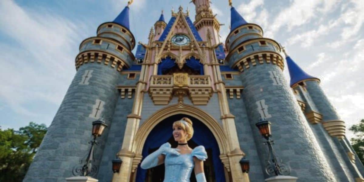 Cinderella standing in front of Cinderella Castle at Walt Disney World's Magic Kingdom
