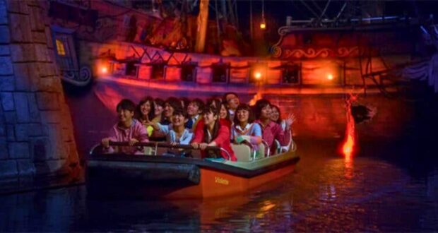 Guests riding a Pirates of the Caribbean boat at Tokyo Disneyland.