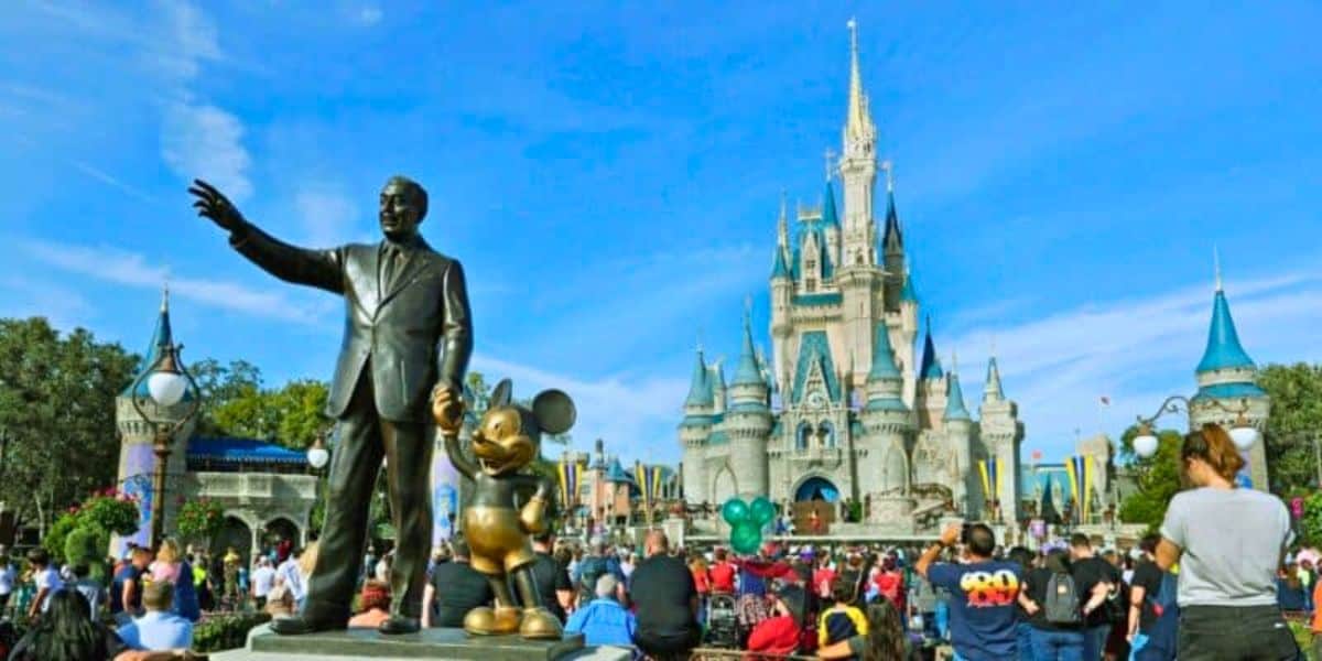 Guests look on inside the Magic Kingdom besides the Walt Disney and Mickey Mouse statue, Partners, at Walt Disney World Resort
