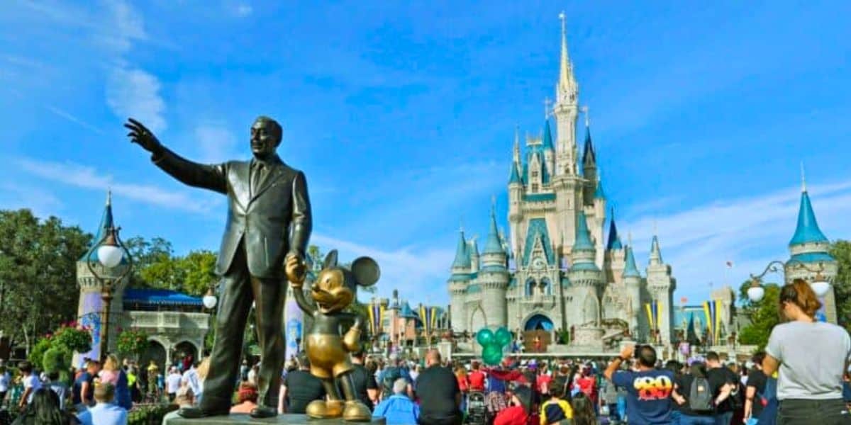 Guests look on inside the Magic Kingdom besides the Walt Disney and Mickey Mouse statue, Partners, at Walt Disney World Resort