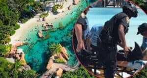 Aerial view of a tropical aquatic park with clear blue water, rocks, and lush greenery. Inset image shows first responders helping a person on a stretcher. The two contrasting scenes indicate an emergency occurred at the otherwise tranquil location.