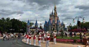 Guests enjoying a performance of the Main Street Philharmonic at Main Street, U.S.A., with Cinderella Castle in the background at Magic Kingdom