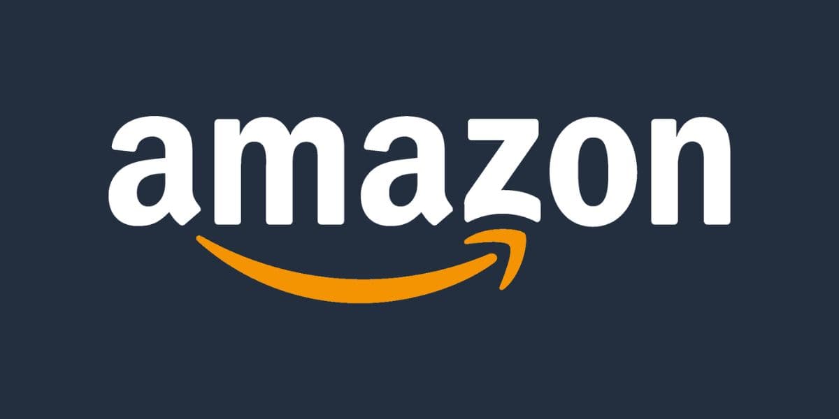 The image displays the Amazon logo, featuring the word "amazon" in white lowercase letters with a yellow, curved arrow underneath pointing from the letter "a" to the letter "z," forming a smile. The background is a dark blue color, reminiscent of the inviting hues you might find at an Amazon Disney Store.