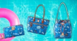 A trio of blue-themed bags and a wallet with travel-related designs are arranged on a vibrant, water-like background. A pink inflatable ring is partially visible on the left, suggesting a poolside or beach setting.