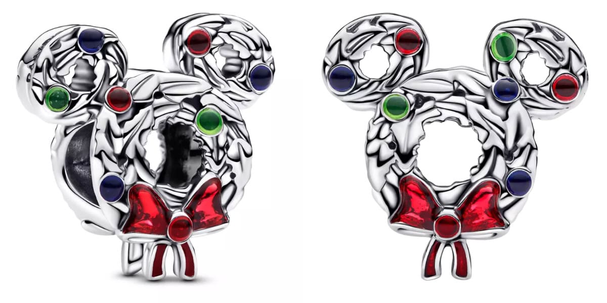 Silver holiday charm shaped like a mouse head, adorned with green, red, and blue gemstones. Features a red bow at the bottom, resembling a festive wreath.