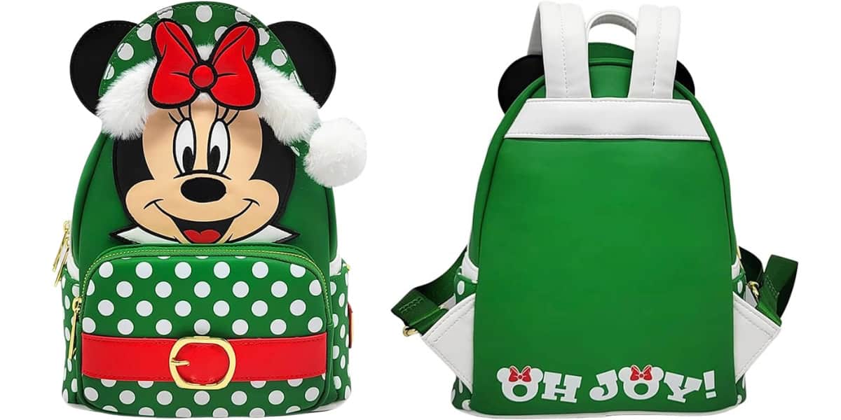 A green holiday-themed backpack with a front design featuring a cartoon character's face wearing a red bow and Santa hat, along with white polka dots, a red belt, and "OH JOY!" text on the back in white, accented with festive motifs.