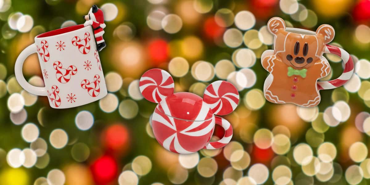 Three festive mugs against a blurred background of colorful lights. A white mug with red candy canes, a Mickey-shaped red and white peppermint mug, and a gingerbread mug with a candy cane handle, creating a cheerful, holiday-themed scene.