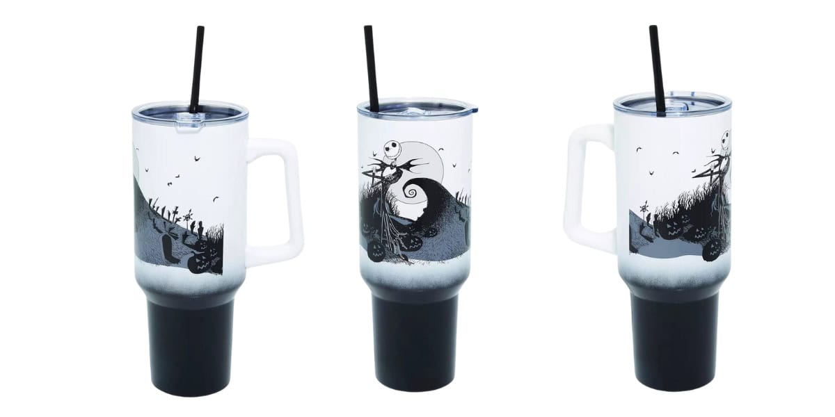 Three travel mugs with handles, featuring a black and white design inspired by a spooky, animated theme. Each mug has a clear lid with a black straw. The design includes a spooky hill, crescent moon, and silhouetted figures.