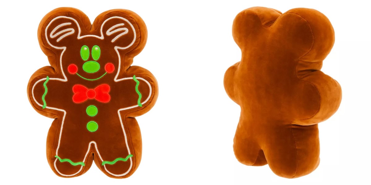 A plush gingerbread man toy, reminiscent of Disney magic, is shown from the front and back. The front features colorful icing details like green eyes, a red mouth with buttons, and a green bow tie. The back remains plain brown, adding to the toy's charming simplicity.