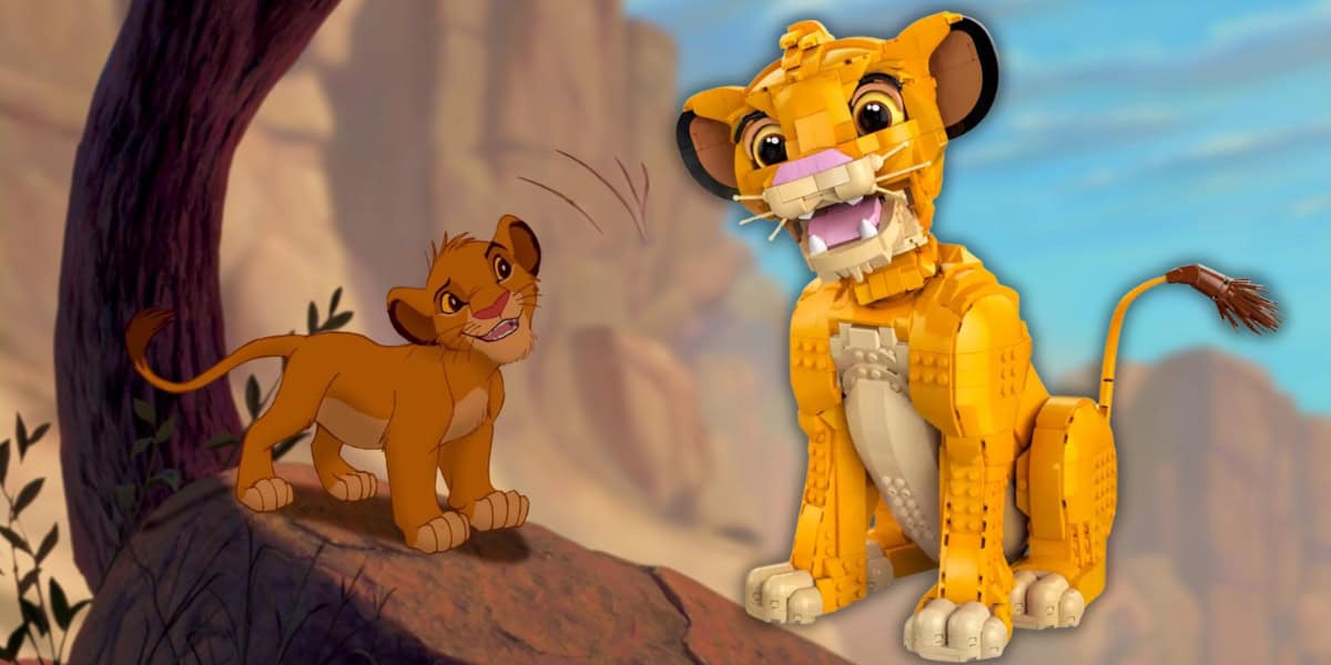Animated young lion on a rock looks up at a large, detailed toy model of a lion cub with an open mouth and expressive eyes, set against a backdrop of rocky terrain and a blue sky.