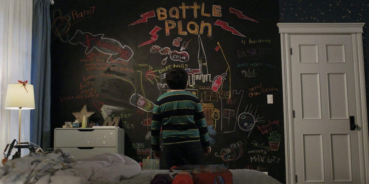 Max Mercer (Archie Yates) looks at his battle plan on the wall in 'Home Sweet Home Alone'