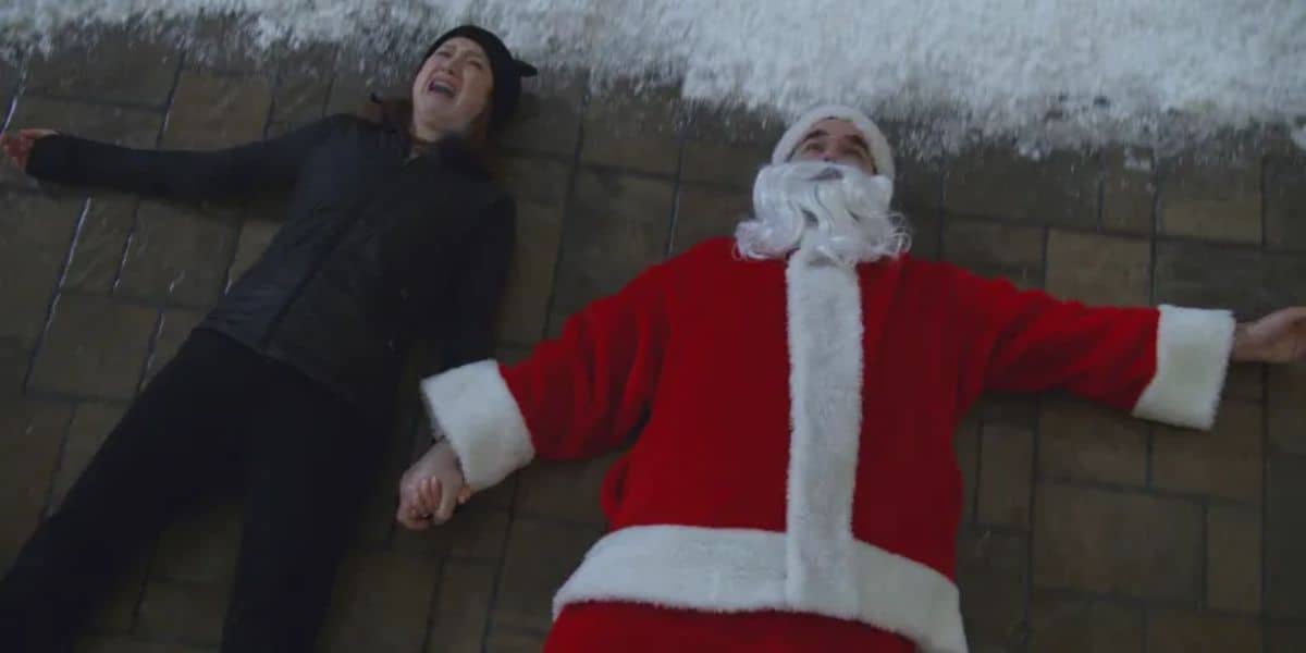 Two burglars, one in a Santa suit, on the ground in 'Home Sweet Home Alone'