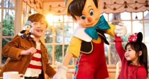 Disneyland Paris guests with a Disney cast member dressed as Pinocchio at restaurant