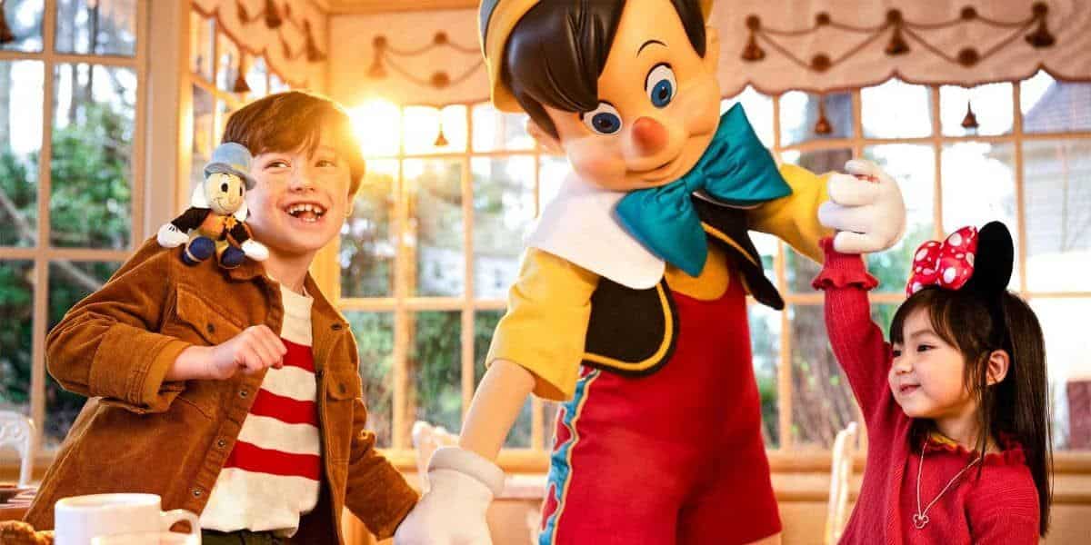 Disneyland Paris guests with a Disney cast member dressed as Pinocchio at restaurant