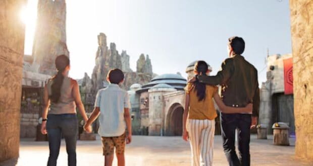 A family walking through Star Wars: Galaxy's Edge at Disneyland.