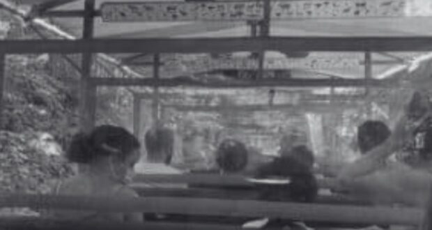 Black and white photo of people sitting inside a Kilimanjaro Safaris ride vehicle.
