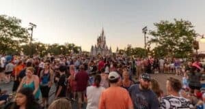A large crowd in Magic Kingdom with Cinderella Castle in the background