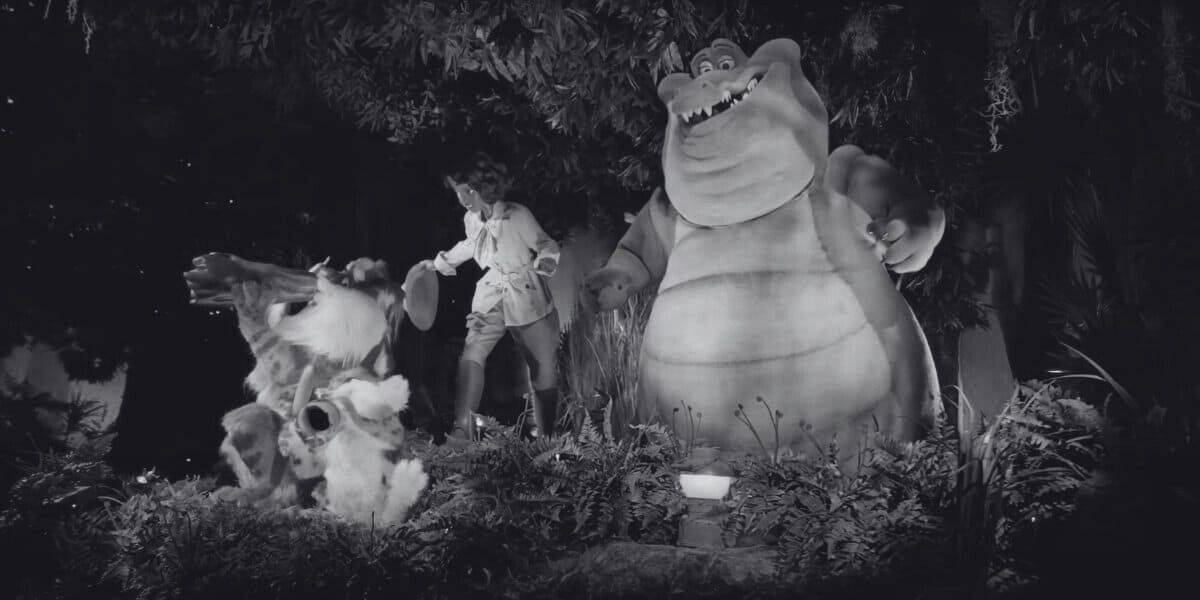 A black and white image of Princess Tiana, Louis, and an animal band on Tiana's Bayou Adventure.