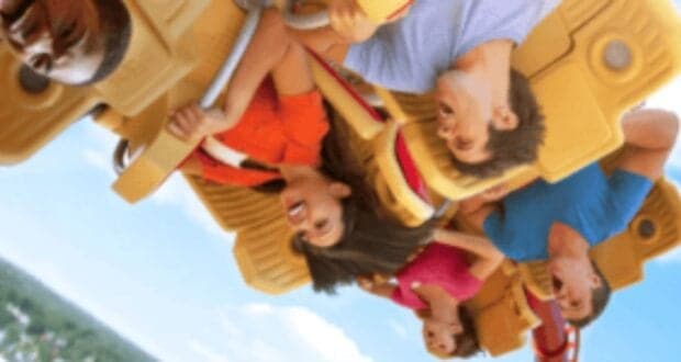 A group of people are riding the Hollywood Rip Ride Rockit roller coaster, hanging upside down.
