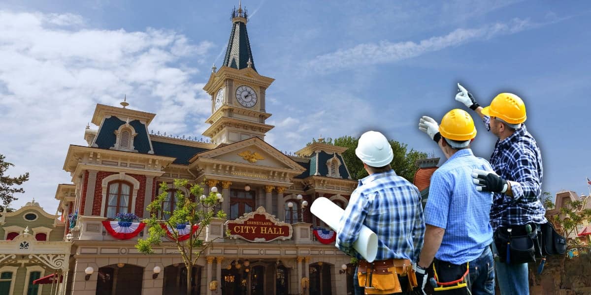 Three construction workers wearing helmets and holding blueprints discuss the architecture of a building resembling a decorative town hall with a clock tower under a clear blue sky. The building has red brick, white columns, and American flag bunting inside of Magic Kingdom, near the Rivers of America location at Walt Disney World Resort.