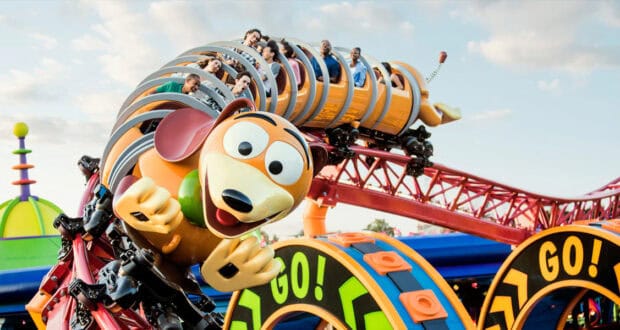 Roller coaster shaped like Slinky from Toy Story, with people riding inside the coils.