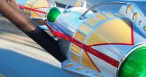 Close-up view of a colorful, futuristic Astro Orbiter ride vehicle.