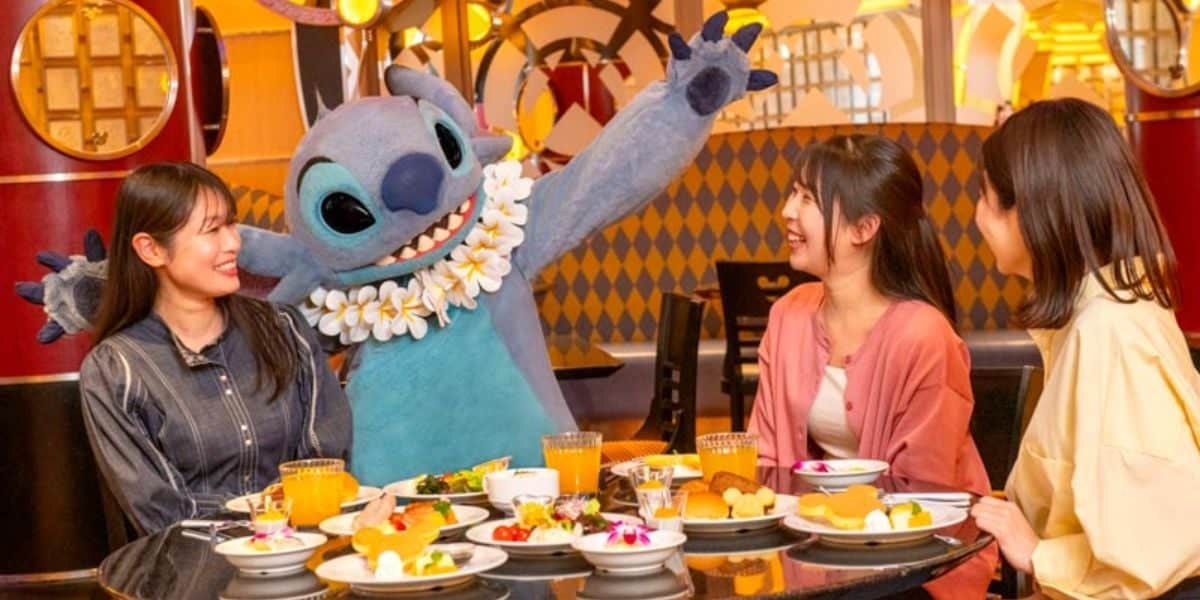 Stitch with three adults at character dining at Tokyo Disney Resort