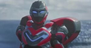A futuristic robot in red, black, and silver armor with glowing blue eyes stands in front of a blurred ocean background.