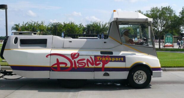 A Disney Transport tram at Walt Disney World Resort with a large "Disney" logo on the side
