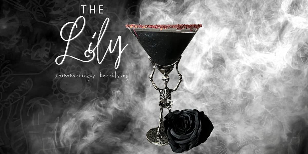 A black cocktail in a skeleton-shaped glass with a red sugar rim and a black rose, set against a smoky, dark background. Text reads: "The Lily, shimmering, terrifying.