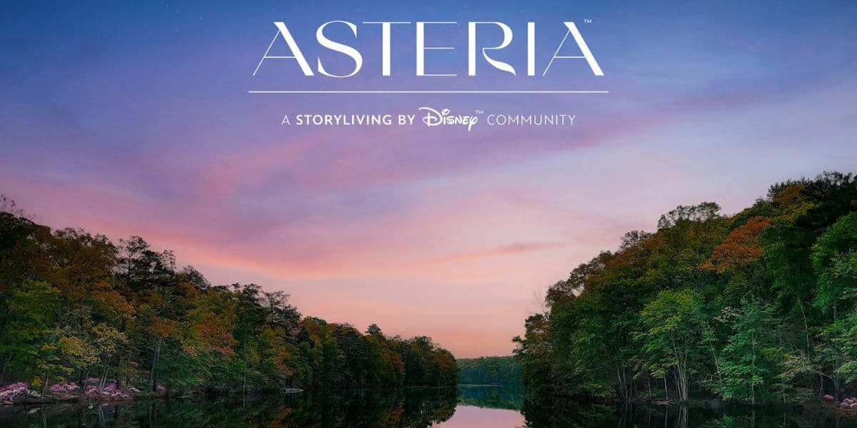 A serene lake surrounded by trees with green and autumn foliage at sunset, under a pink and blue sky. The text "ASTERIA, A Storyliving by Disney Community" appears at the top, celebrating Disney North Carolina Asteria Community's initial town approval.