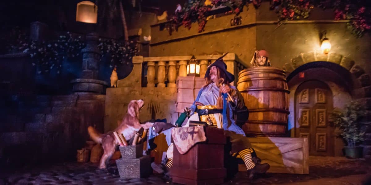 Several animatronics on the Pirates of the Caribbean ride, including a man and a dog.