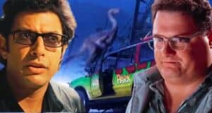 Ian Malcolm (Jeff Goldblum) and Dennis Nedry (Wayne Knight) looking shocked against a "Jurassic Park: Survival" T-Rex paddock backdrop