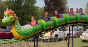 Children on a dragon roller coaster after an accident that caused the wheels to fall off.