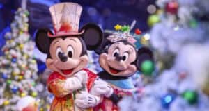Mickey Mouse and Minnie Mouse dressed in festive holiday outfits at Disneyland Paris