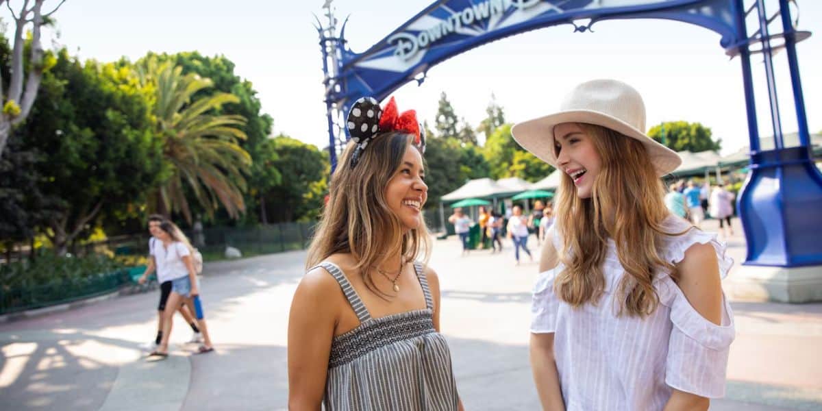 Two young women outside the entrance of Downtown Disney
