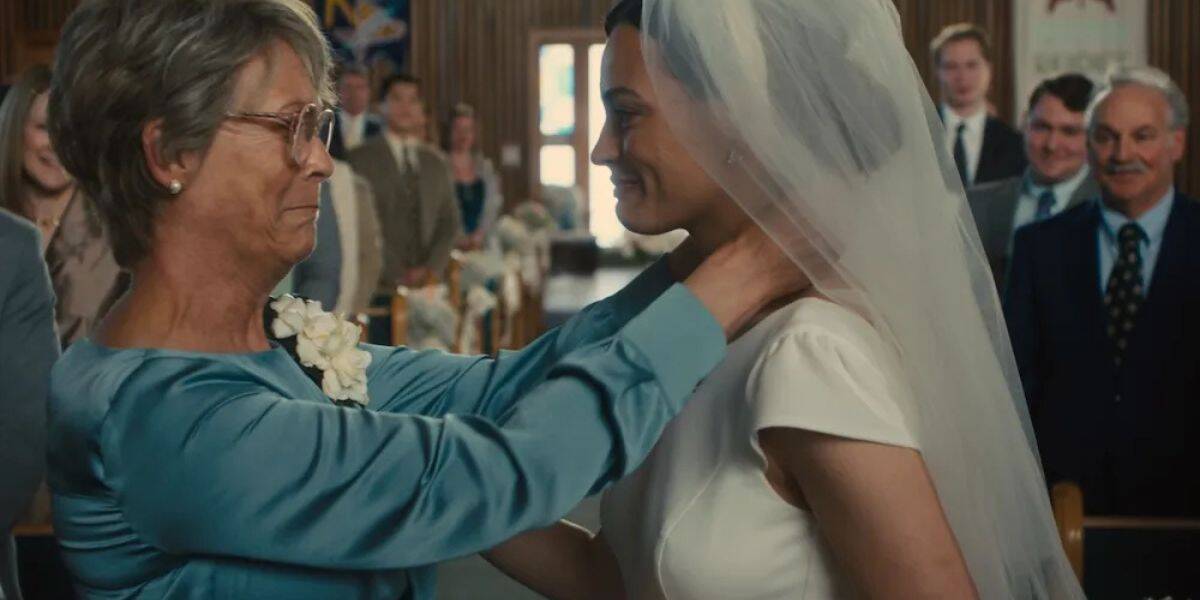 A grandmother beams with tears of joy at a bride in her gown and veil, surrounded by the grandeur of a cathedral setting.
