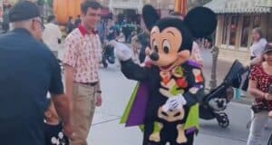 Mickey Mouse pointing at a father