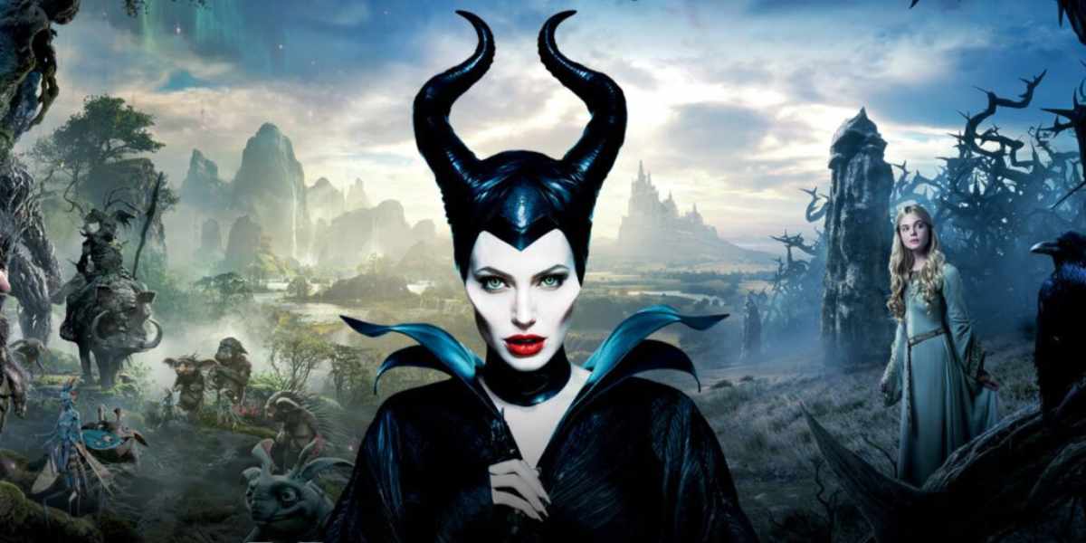 Maleficent, with signature black horns and red lips, faces Aurora in her blue gown amid a magical fantasyland backdrop.