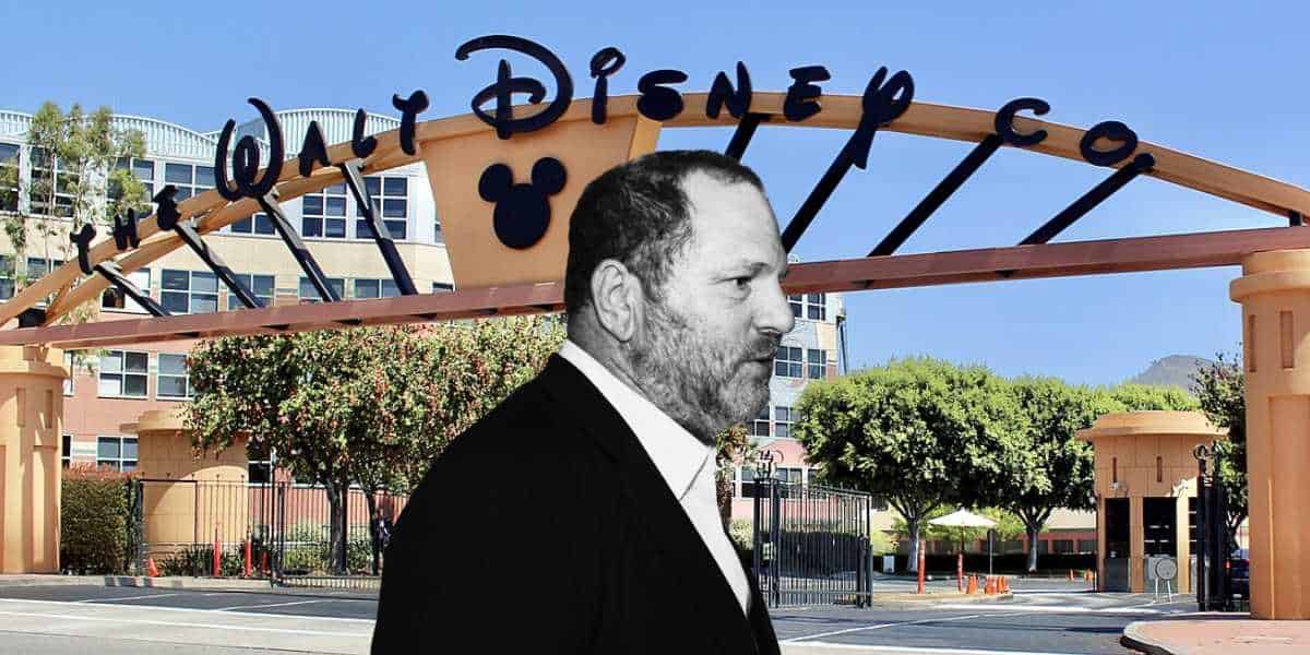 A grayscale Walt Disney stands before the iconic Disney Co. entrance gate on a sunny day, recalling the brand’s storied legacy.
