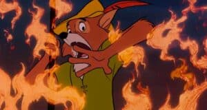 Robin Hood, in his signature green shirt and hat, appears startled as flames blaze around him during the parade spectacle.
